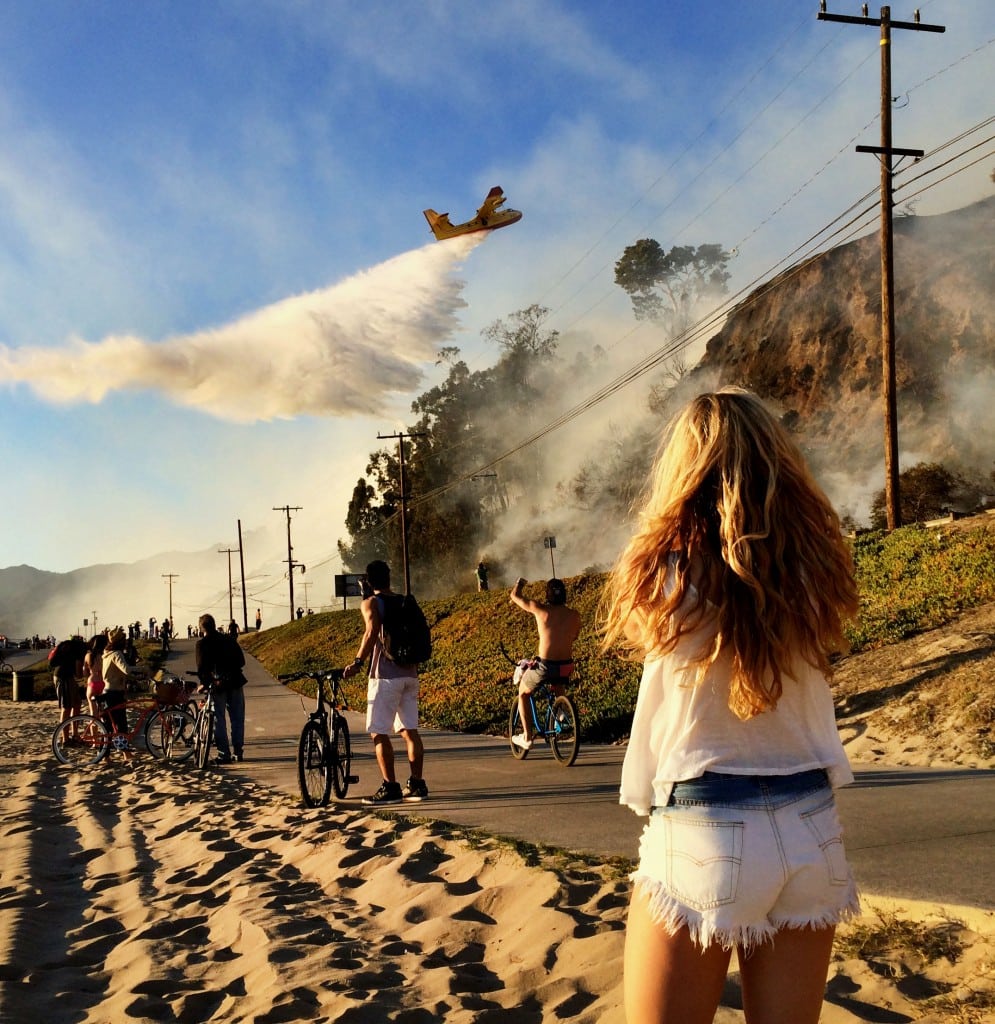 Spectator watches firefighting effort on the Pacific Coast Highway