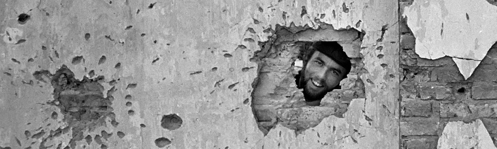 VIETNAM - - 1973: Photographer David Hume Kennerly behind a shell-pocked wall, Vietnam, 1973. Courtesy of David Hume Kennerly