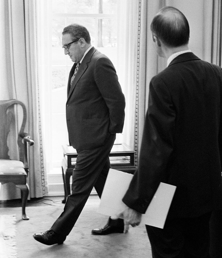 WASHINGTON -- APR 29: 6:15 PM. Secretary of State Henry Kissinger paces in his White House office as Deputy National Security Advisor Brent Scowcroft and he discuss why 11 Marines were stranded on the roof of the U.S. Embassy. Fortunately they were rescued a coupe of hours later. Washington, D.C.,  April 29, 1975. (Photo by David Hume Kennerly/GettyImages).