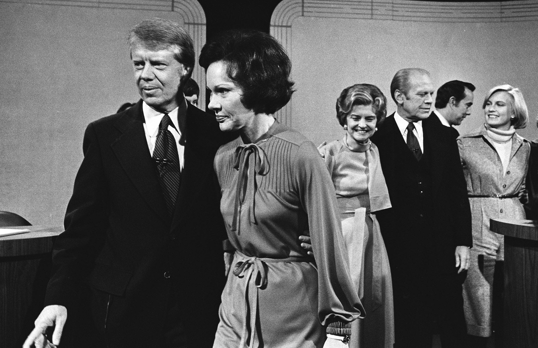 Democratic presidential nominee Jimmy Carter and wife Rosalynn walk away from the President and Mrs. Ford after their third and final debate at William &amp; Mary College, Williamsburg, Virginia, Oct. 22, 1976. FordÕs running mate Sen. Bob Dole talks to Susan Ford behind them. Carter won the election eleven days later.