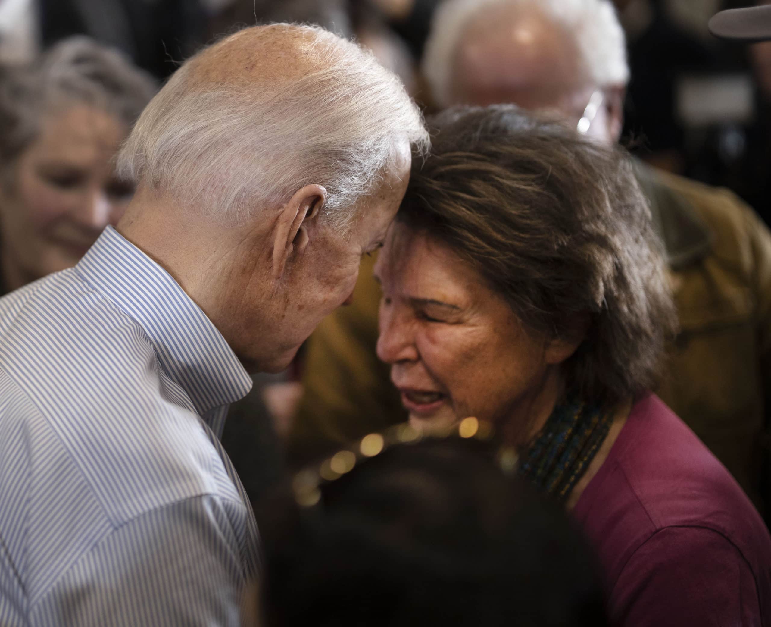 Democratic presidential candidate former Vice President Joe Biden has some comforting words for a woman who suffered a recent loss as he campaigned in Hampton, New Hampshire, February 9, 2020. Biden went on to win the Democratic nomination.