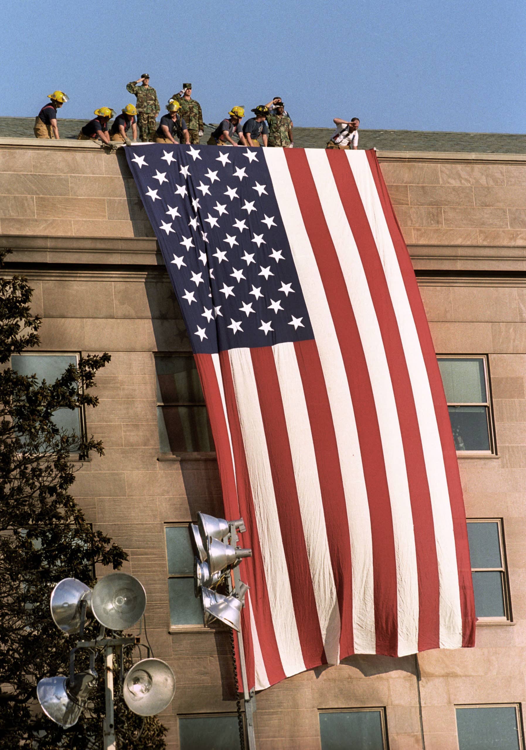 WASHINGTON - - Sept 12:The day after.  A giant American flag is unfurled by military personnel and firefighters next to where a plane crashed into the Pentagon, September 12, 2001. (David Hume Kennerly/Center for Creative Photography/University of Arizona).