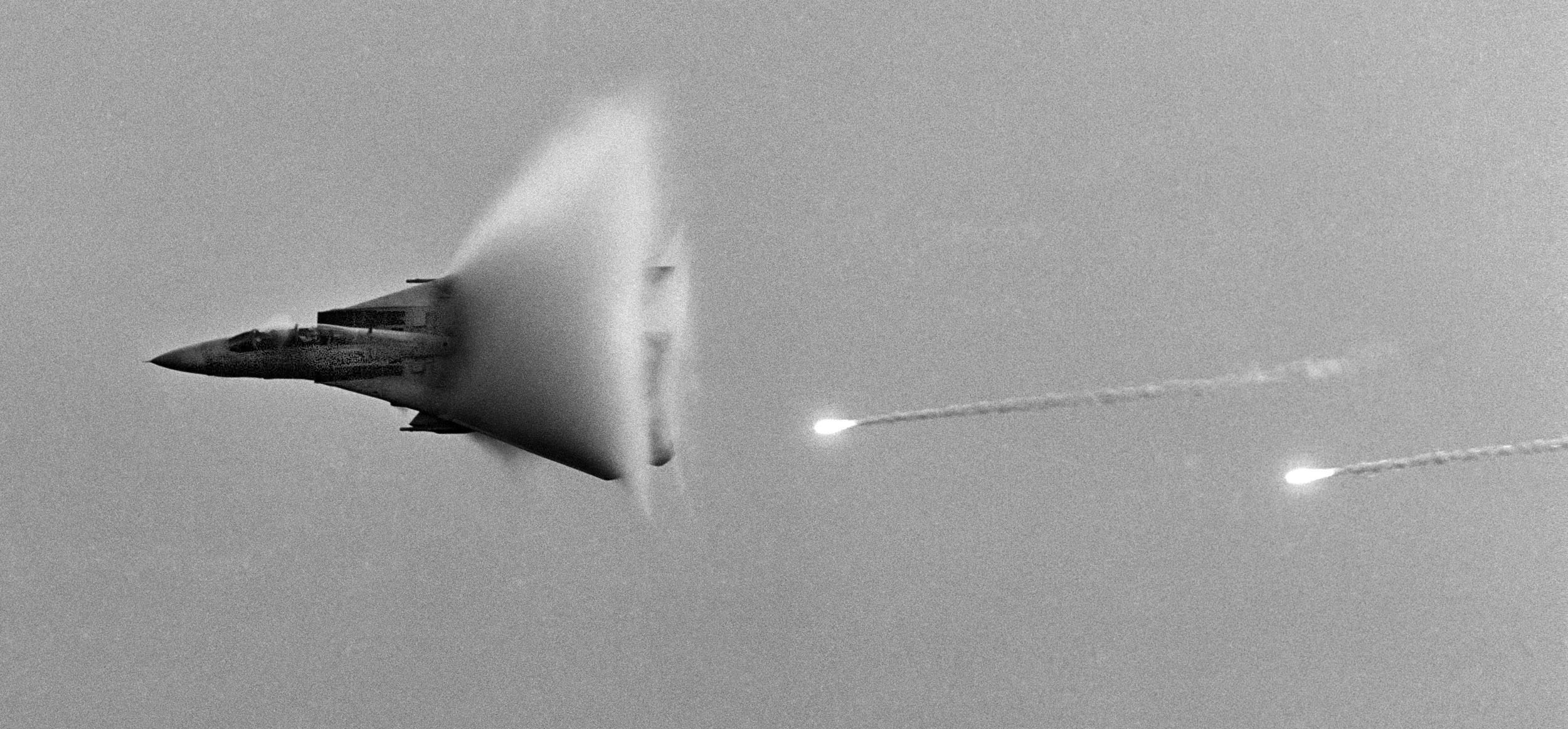 SONIC BOOM

A jet fighter drops flares and breaks the sound barrier as it flies by the U.S. aircraft carrier John F. Kennedy in the Arabian Sea off the coast of Pakistan. The carrier was conducting combat operations into Afghanistan.