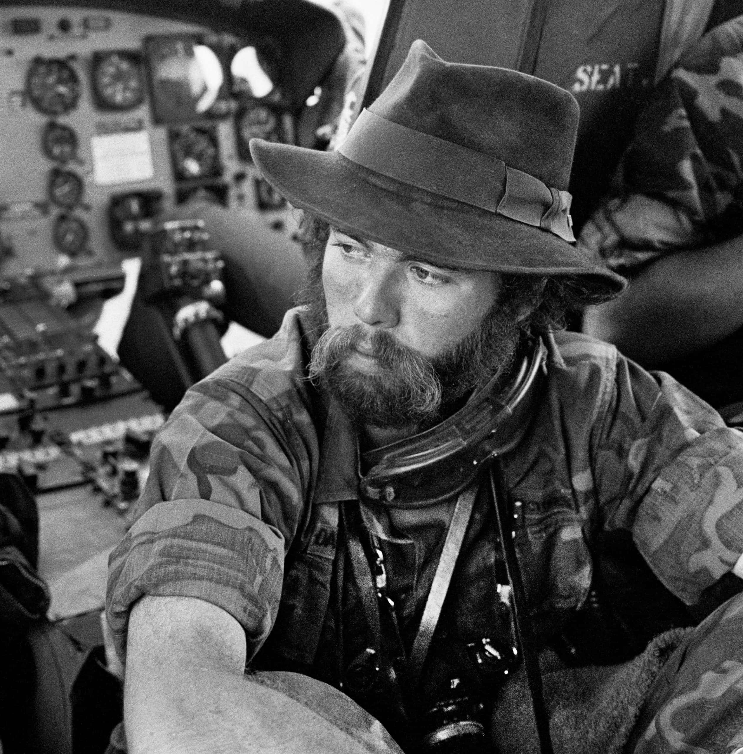 In a helicopter on the way to a hot LZ near Pleiku wearing my signature fedora (photo by Matt Franjola)
