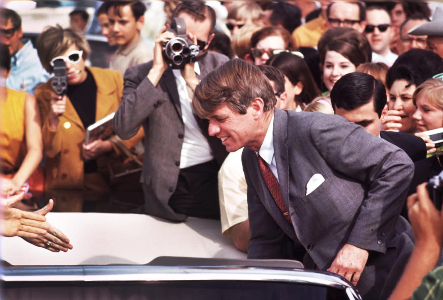 Robert Kennedy by car in Phoenix Arizona amist a crowd including many journalists