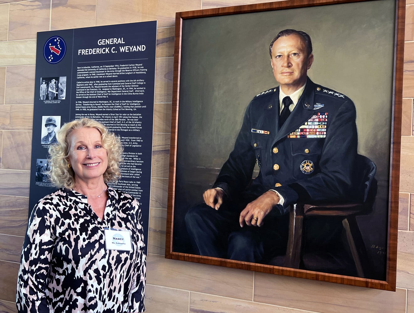 Nancy Hart Kuboyama, General Weyand’s daughter with portrait of her dad in the building that now bears his name at Ft. Shafter, Hawaii