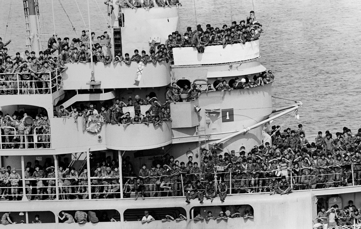 A ship crowed with fleeing South Vietnamese troops in Cam Ranh Bay. Some of them fired at my helicopter