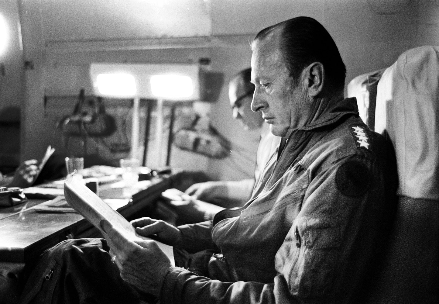 On the flight from Saigon to the U.S. Weyand prepares his report for the president