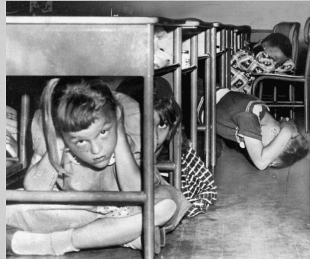 A duck and cover drill from the 50’s. It was important to cover your ears . . . (National Archives)