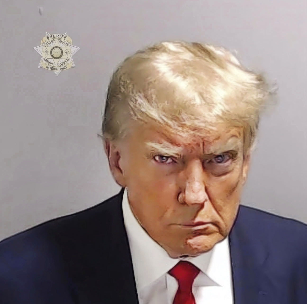 The former president glowers for his booking photo. Rather than a painful moment as it would be for most normal people, he turned it into a fundraising opportunity. The grift goes on.