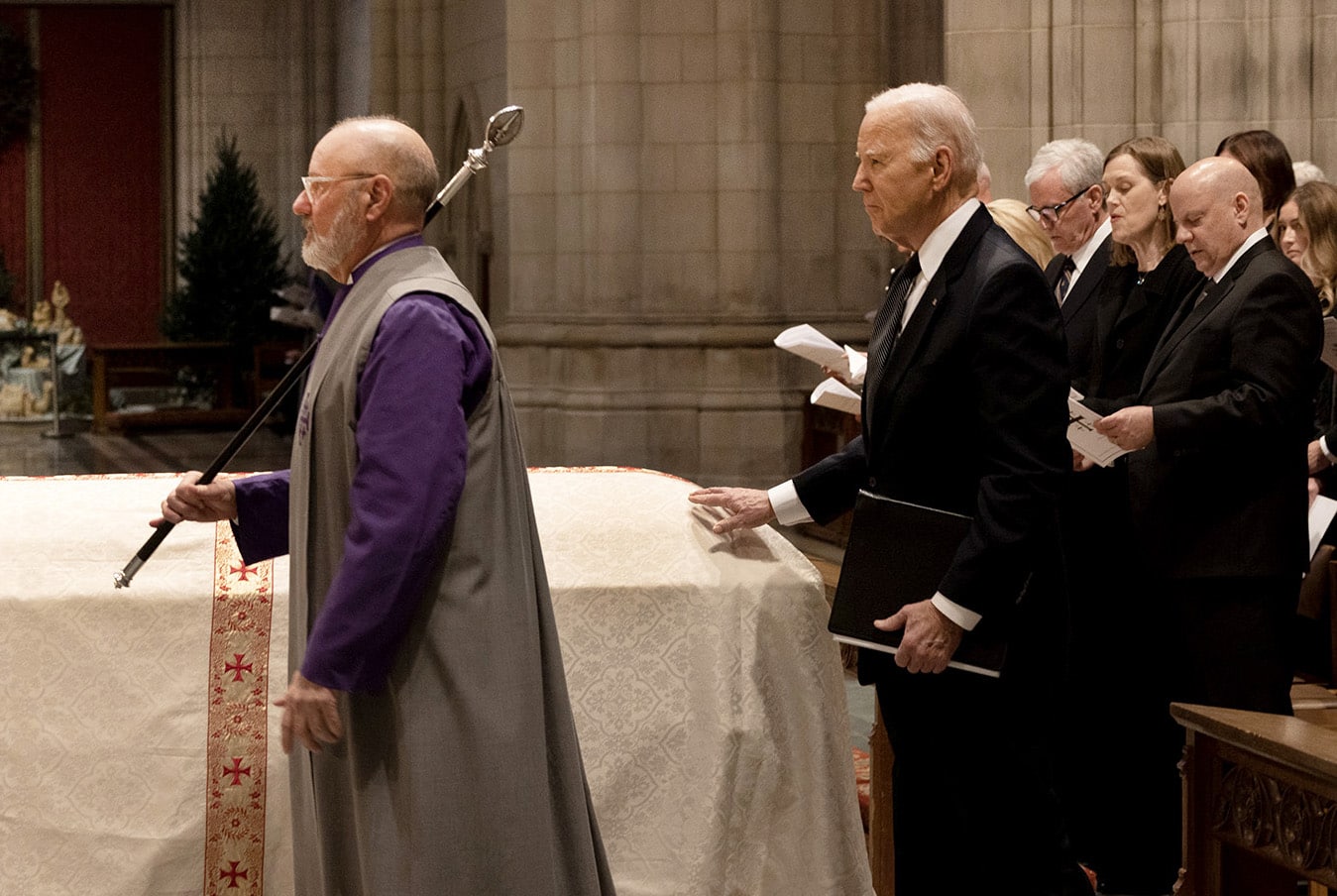 President Joe Biden touches Justice O’Connor’s casket during services at the National Cathedral 