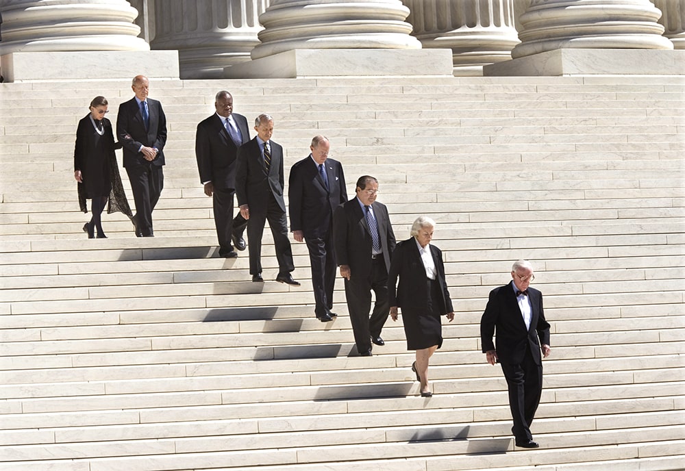 (L-R) Ruth Bader Ginsburg, Stephen Breyer, Clarence Thomas, David Souter, Anthony Kennedy, Antonin Scalia, Sandra Day O'Conner and John Paul Stevens descending the front steps of the Court on their way to the funeral for Chief Justice William Rehnquist, September 7, 2005