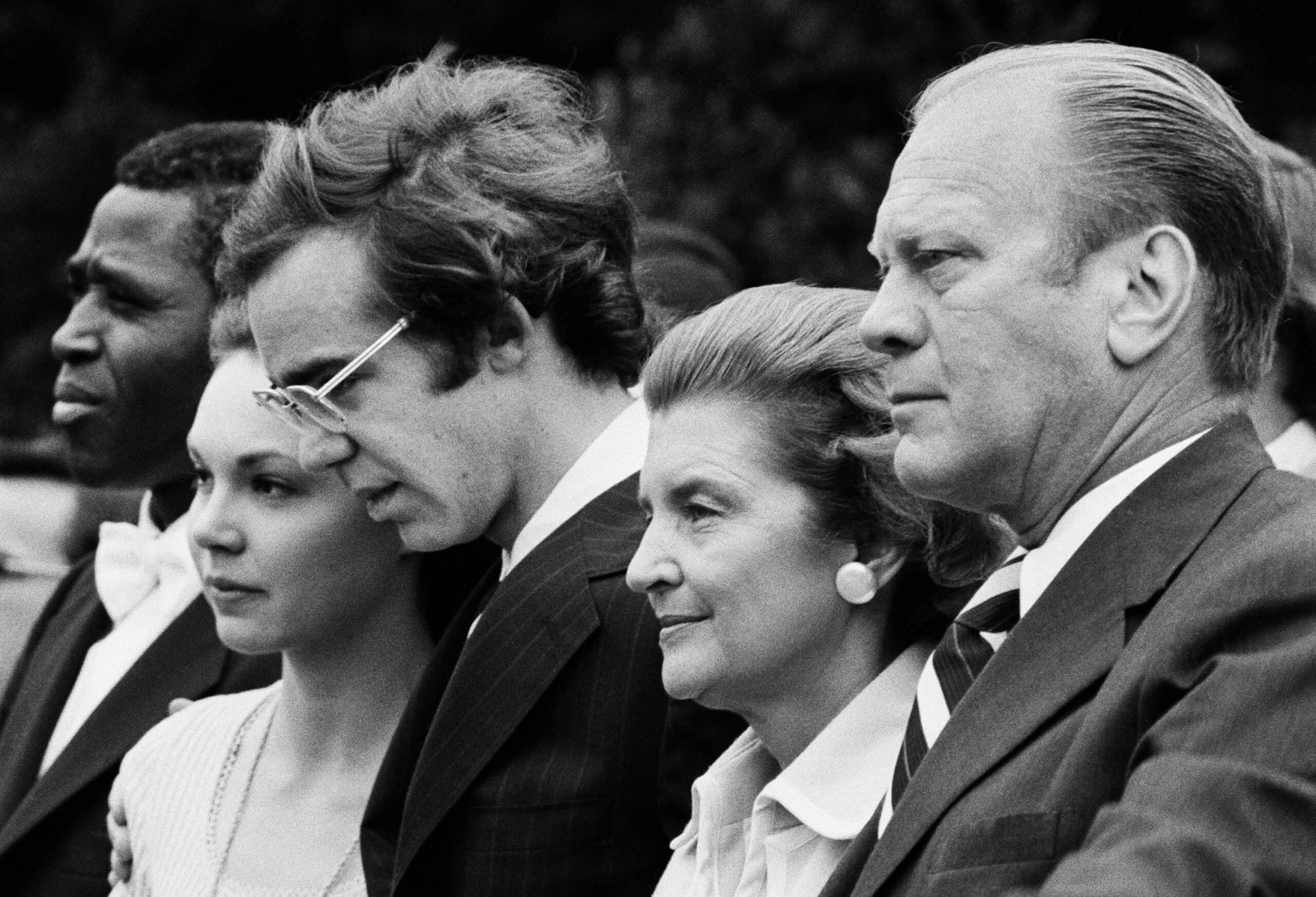 Vice President and Mrs. Ford and David and Julie Eisenhower watch Nixon's helicopter depart