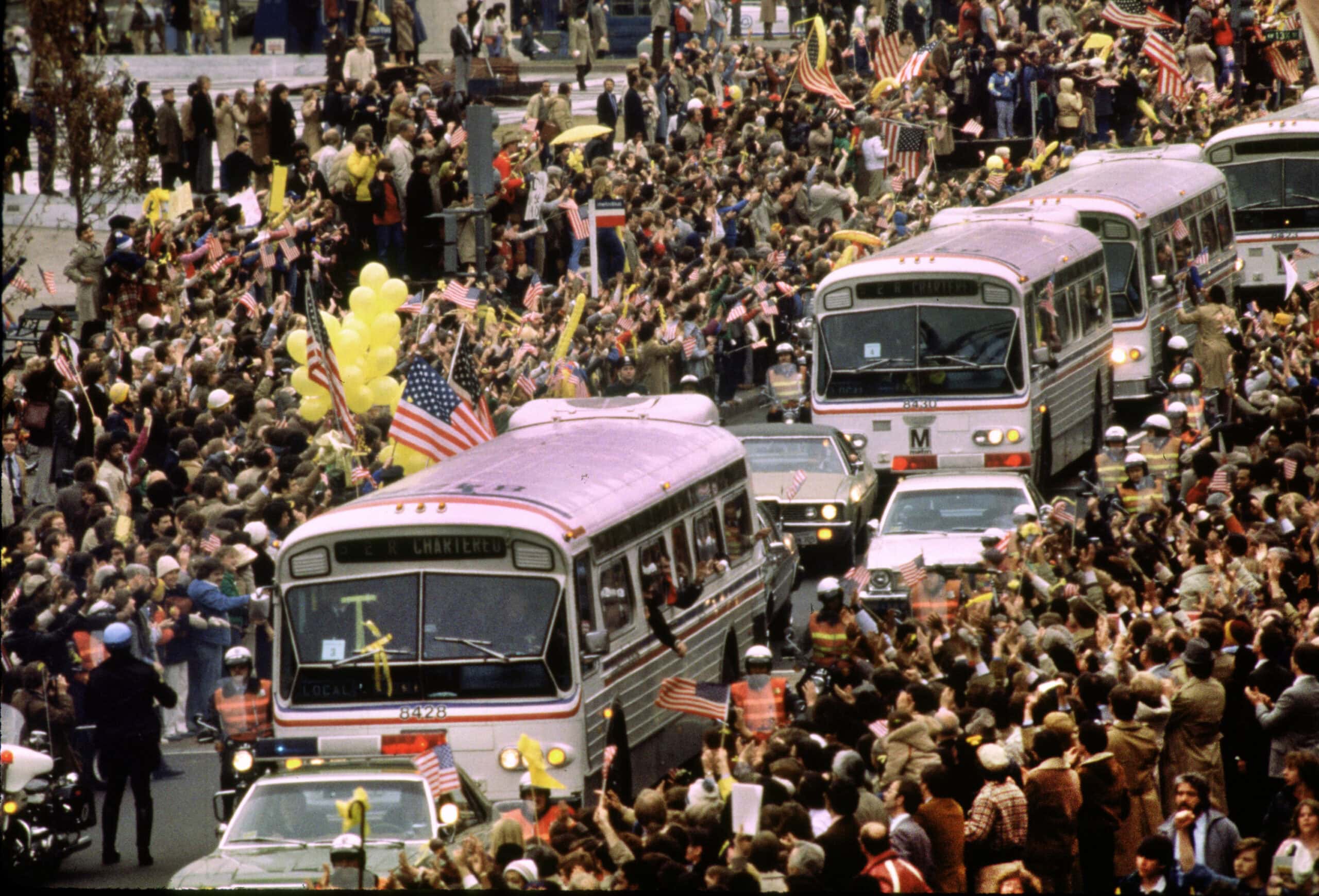 Recently freed Americans held hostage by Iran during Carter’s Administration aboard buses on Pennsylvania Ave., Jan. 27, 1981